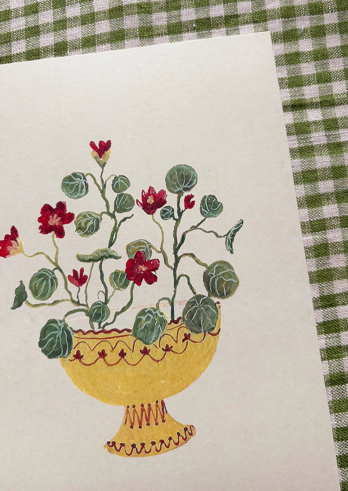 An art print of a painting of crimson nasturtiums in a yellow compote bowl.