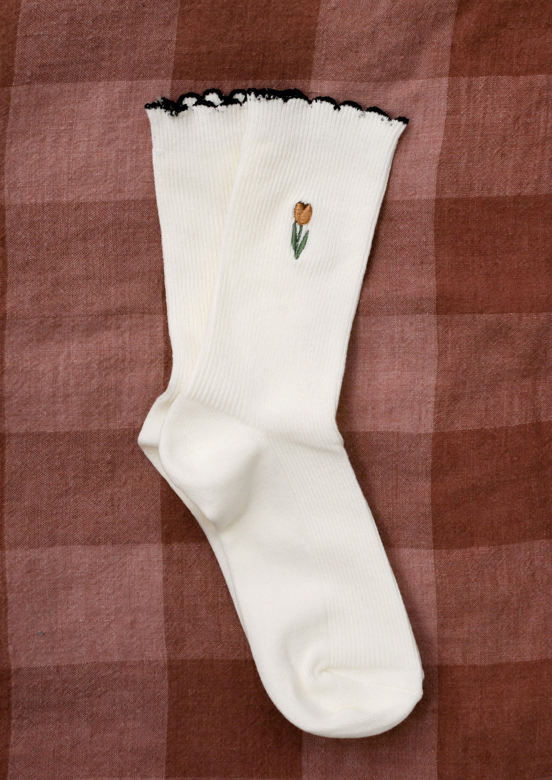 White cotton socks with pink embroidered tulip.