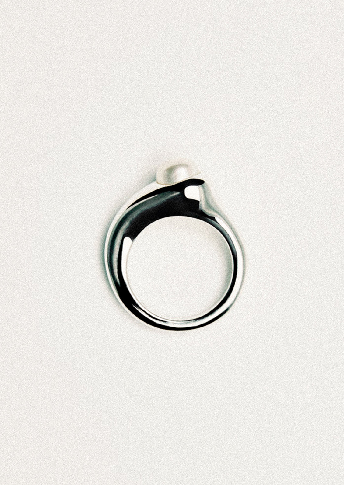A high polish ring with pearl stone.