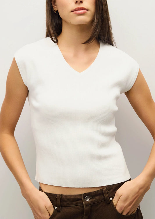 A person wearing a cap sleeve fitted v-neck tee in white.