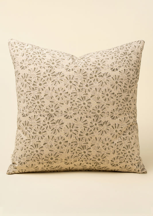 A square throw pillow with a beige and brown floral lace-like pattern, set against a solid cream background.