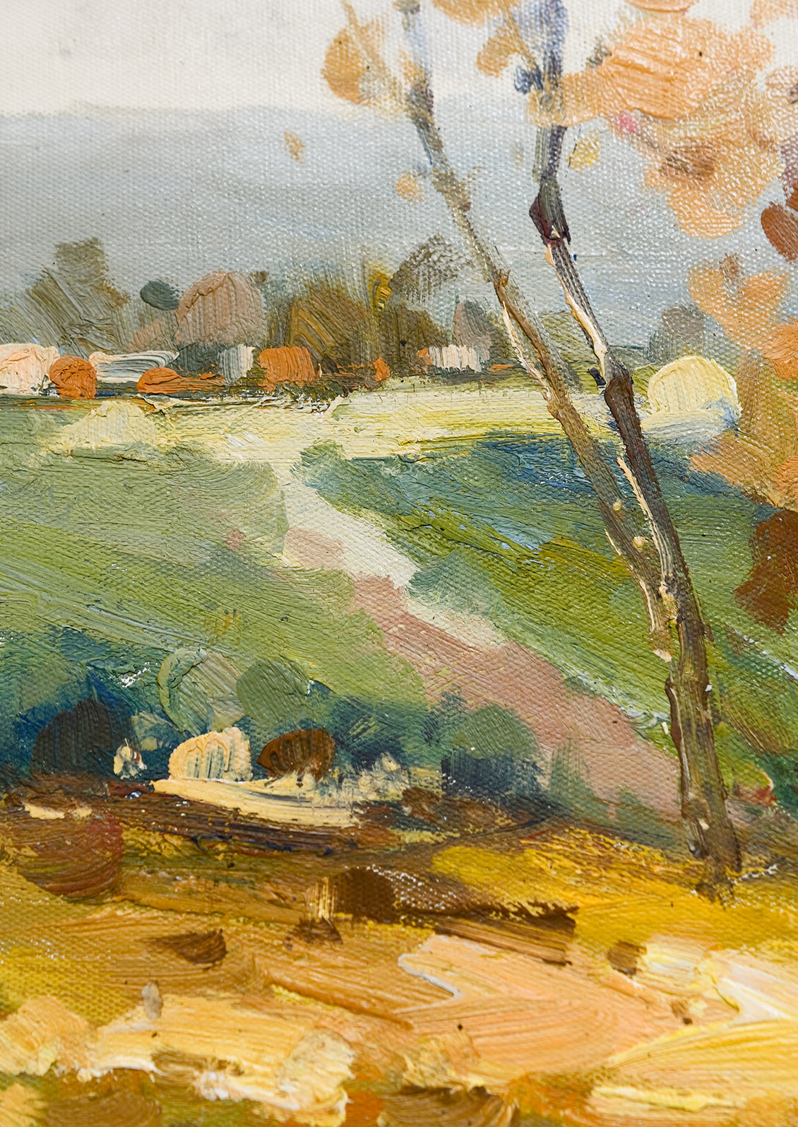 A framed oil landscape painting of two trees next to a pond with houses in the distance.
