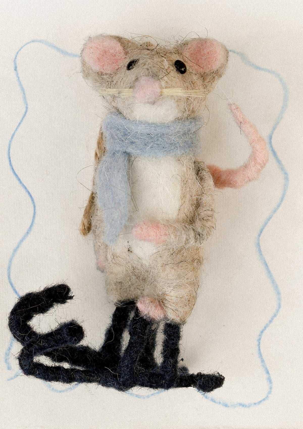 A decorative ornament of a mouse on skis.