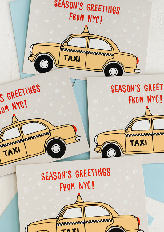 A set of cards with screen printed taxi design, text reads "Season's Greetings from NYC!".