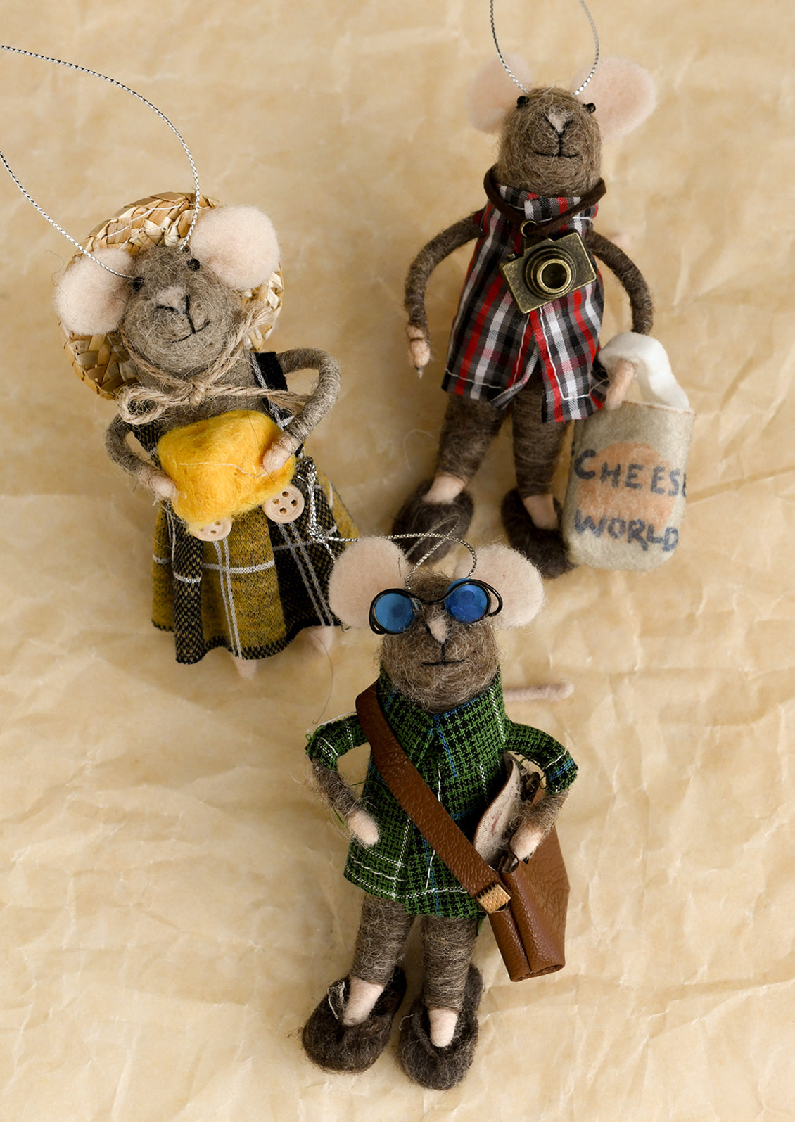 An assortment of mice felt ornaments dressed as tourists of a cheese factory.