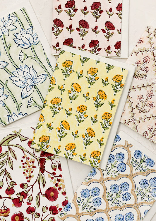 An assortment of block printed floral patterned cards.