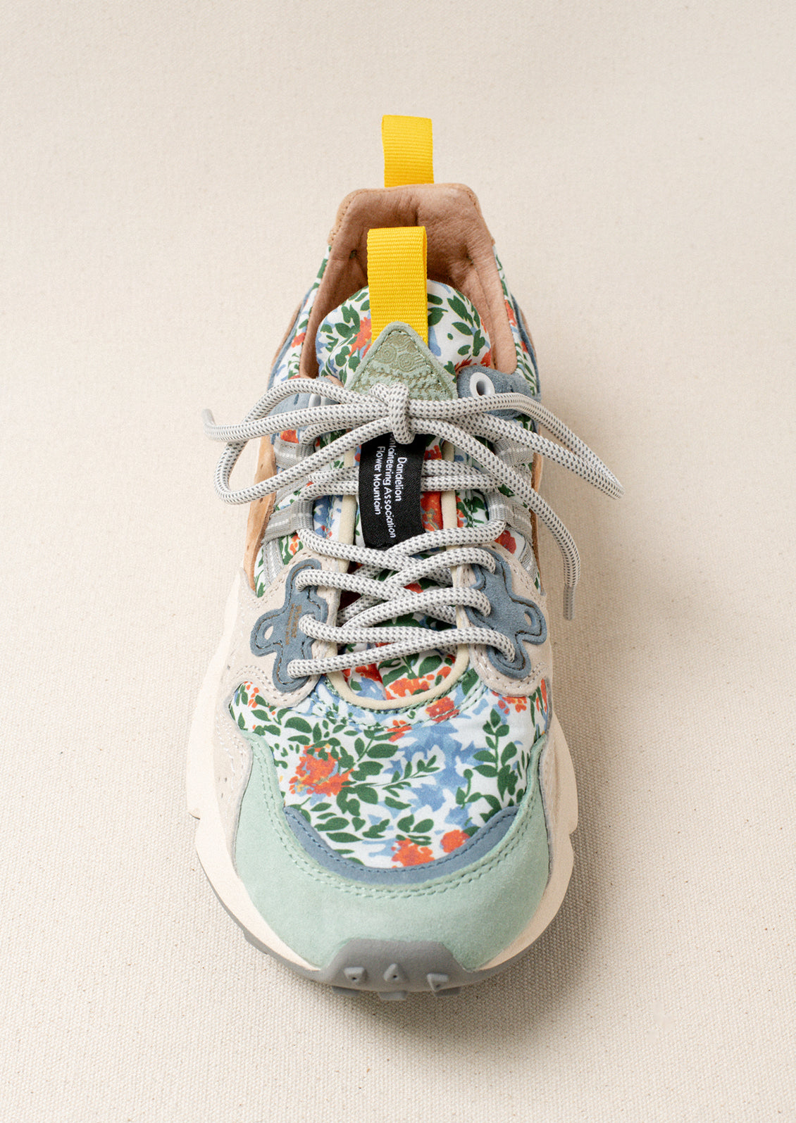 A pair of sneakers with floral print upper.