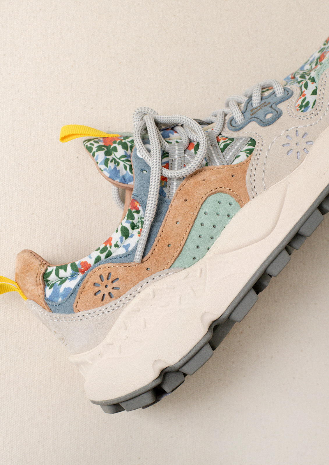 A pair of sneakers with floral print upper.