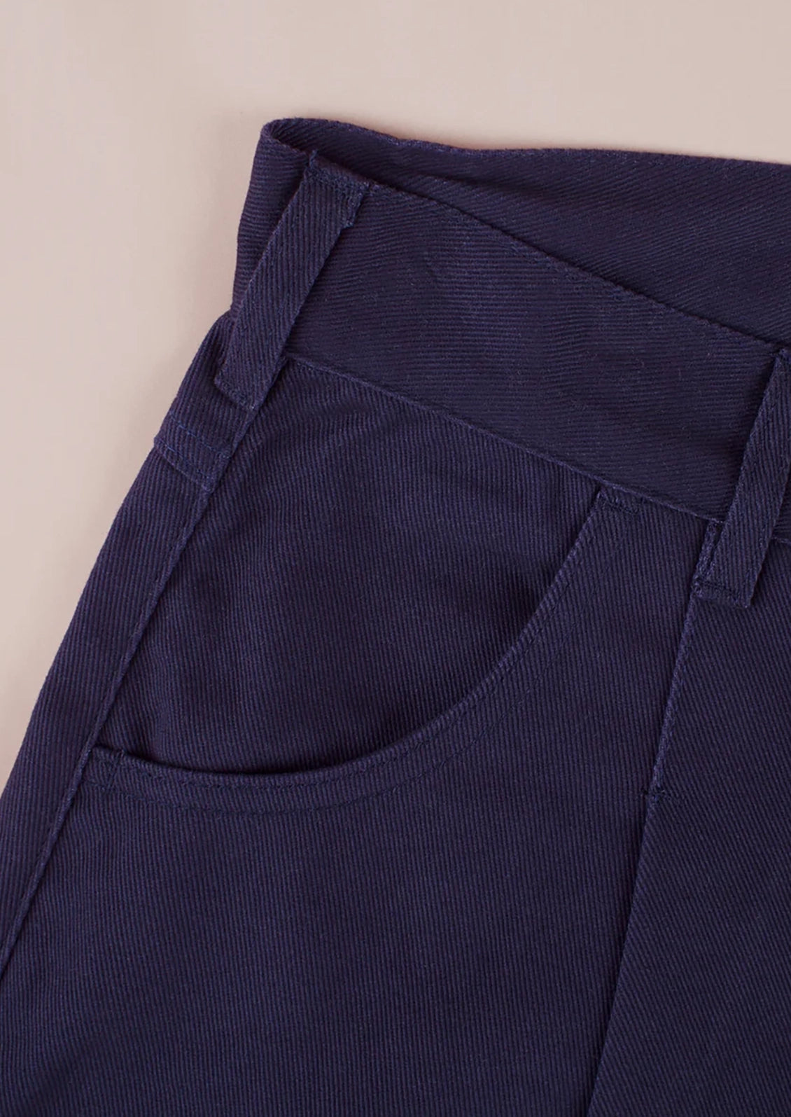 A pair of pants made from navy blue twill fabric.