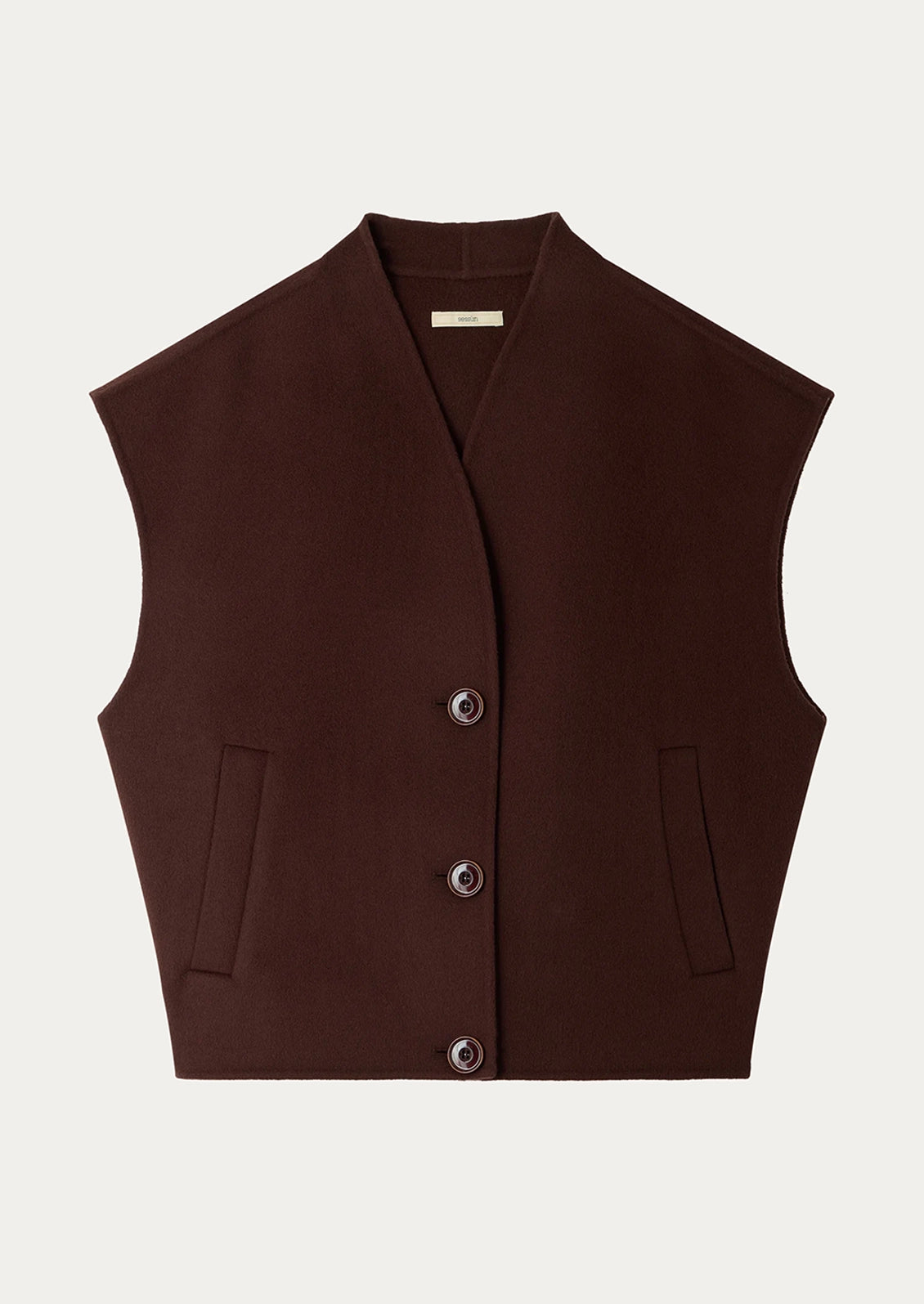 A dark brown sleeveless cropped vest with a V-neck, three front buttons, and two vertical welt pockets on a light gray background.