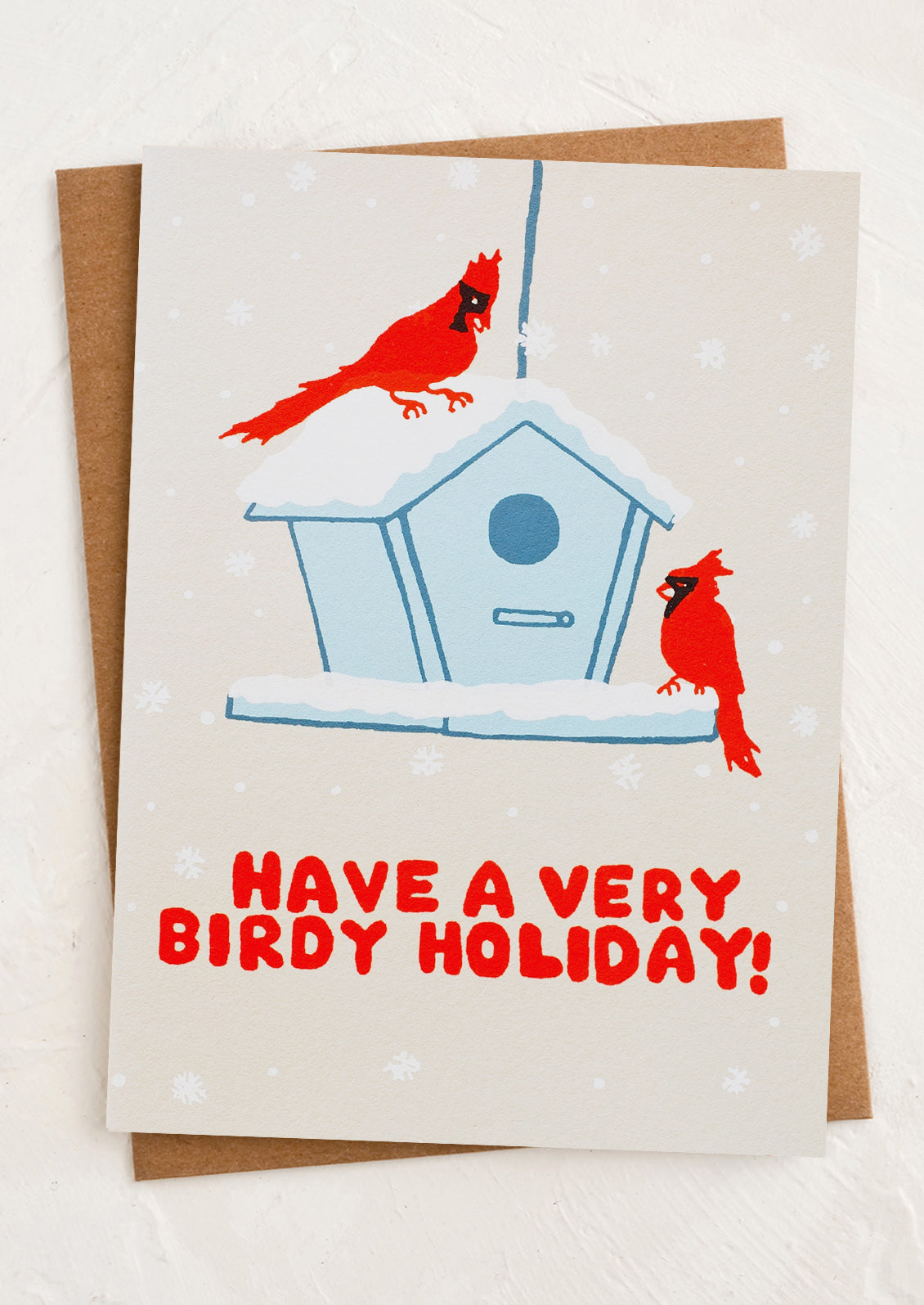 A greeting card with image of cardinals at a bird feeder, text reads have a very birdy holiday.