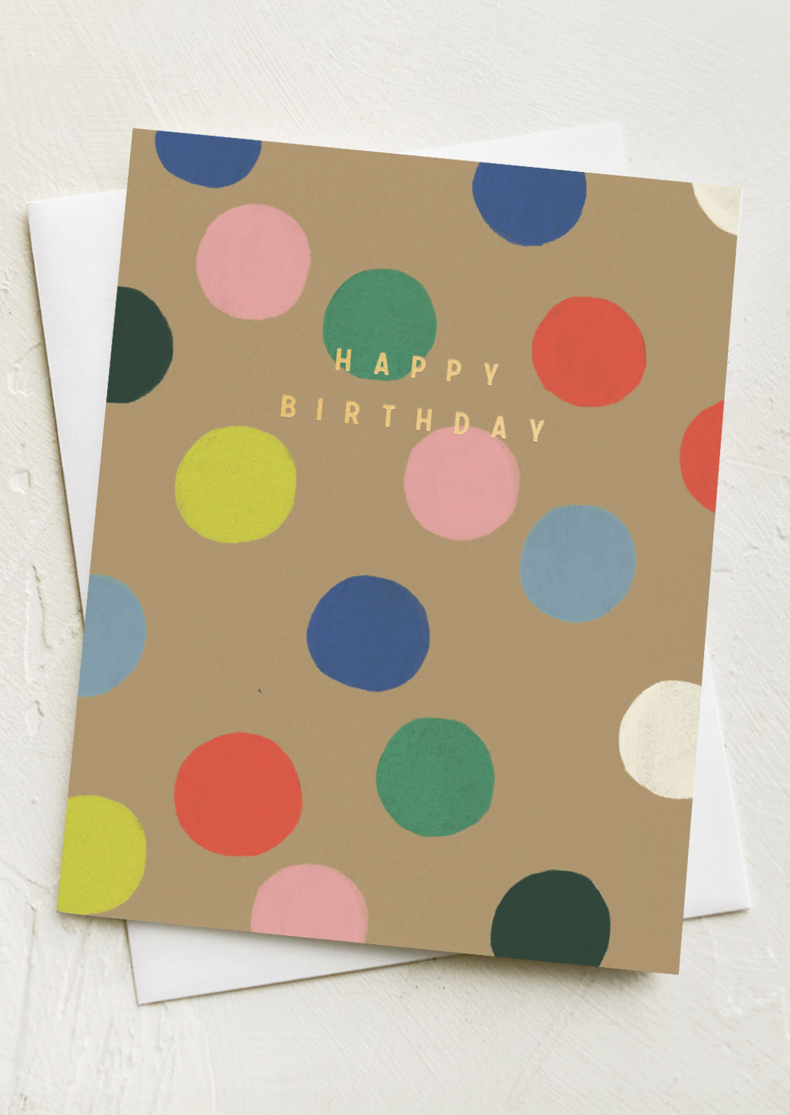 A greeting card with colorful dot pattern, gold lettering reads "Happy Birthday".