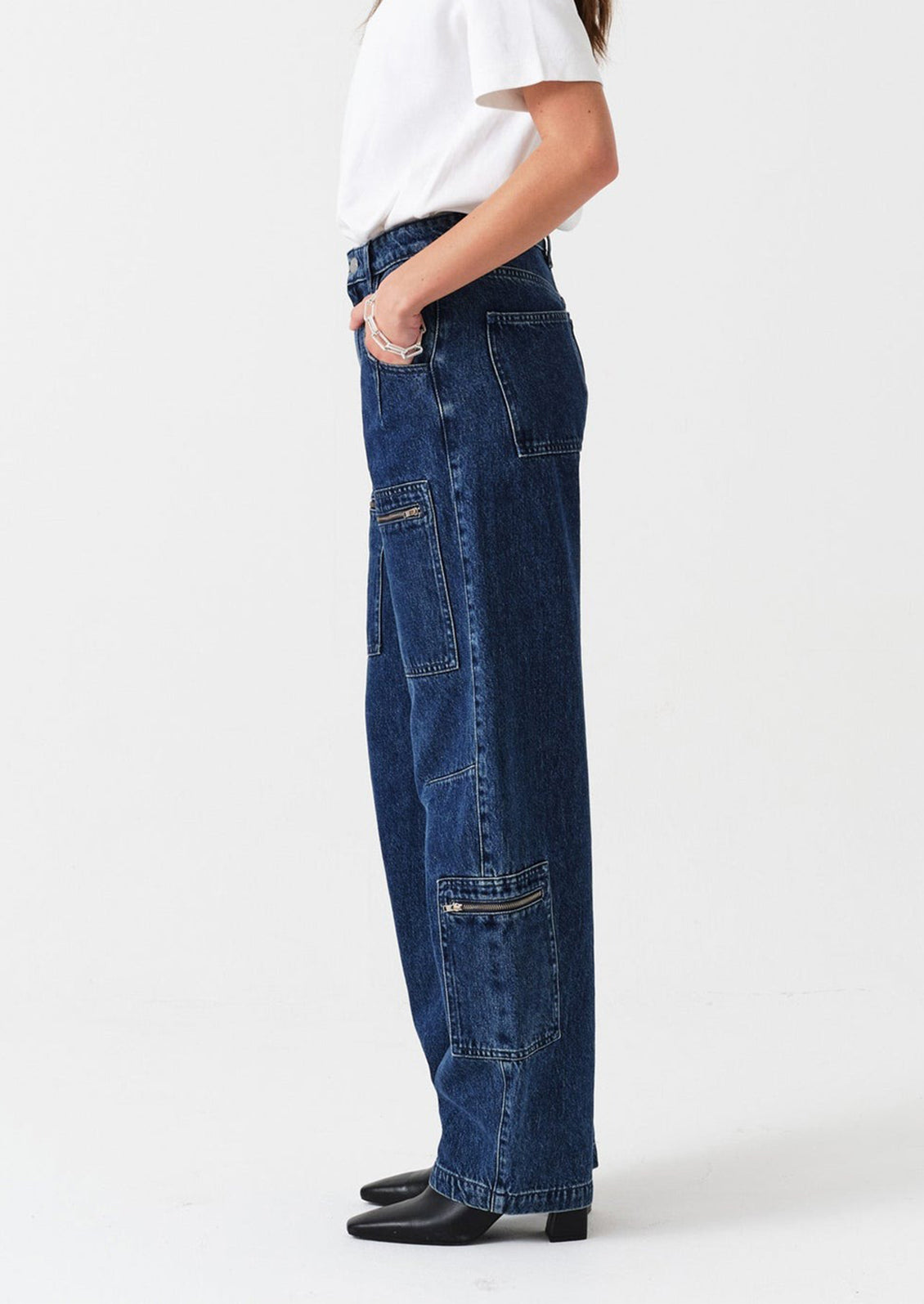 Person wearing blue jeans on a white background
