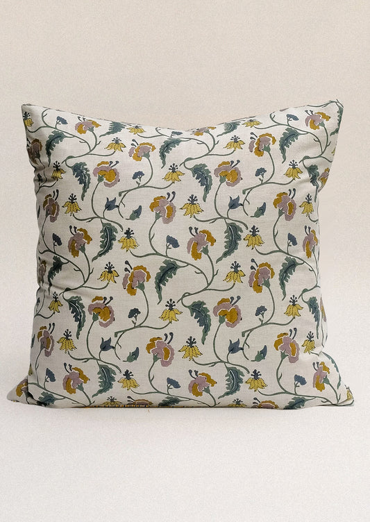 A block printed throw pillow with floral print on natural linen.