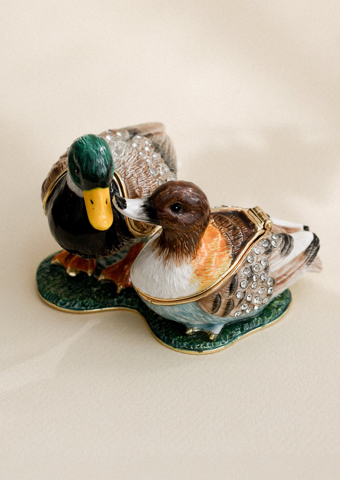 A crystal detailed metal trinket box depicting a pair of ducks (male and female).