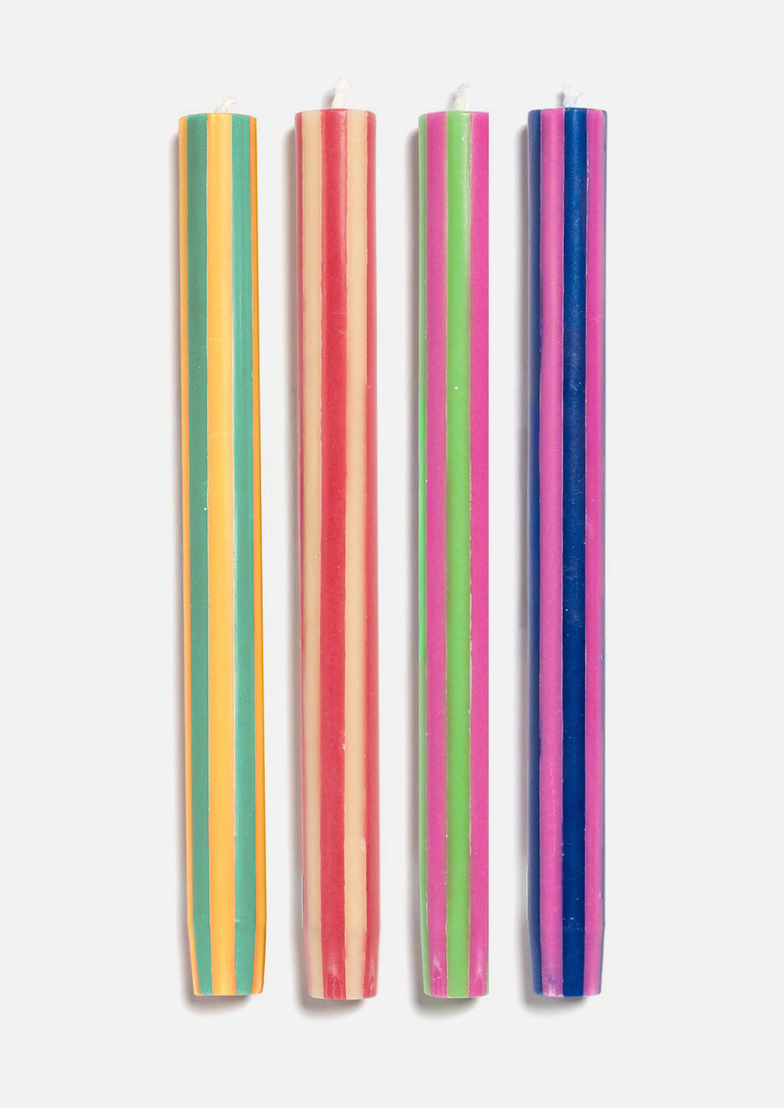 A set of striped taper candles in varying bright hues.