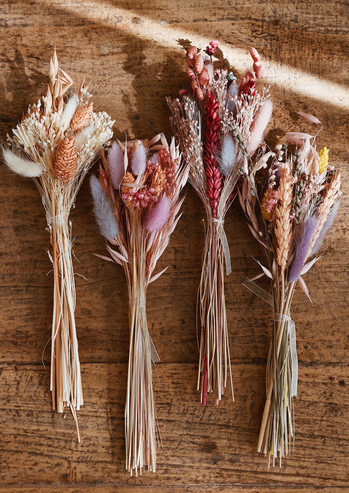 Dried floral bundles in assorted colors.