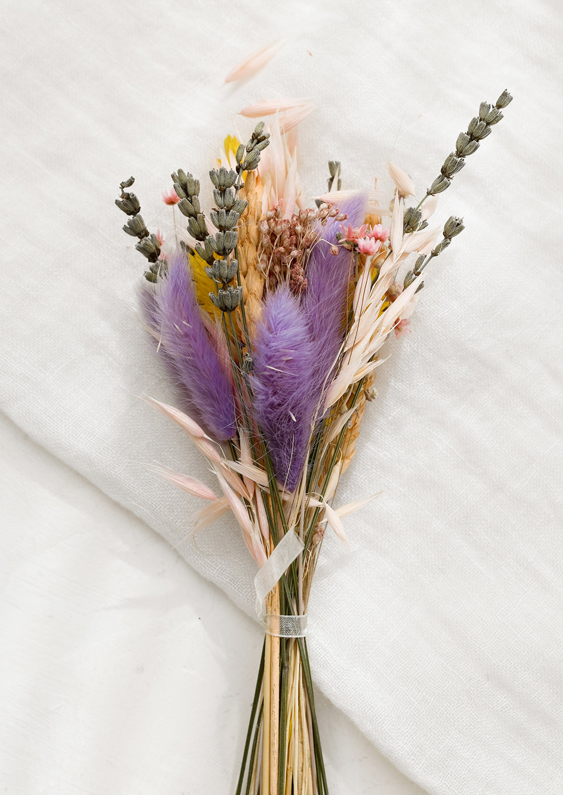 A dried bundle of flowers in lavender multi.