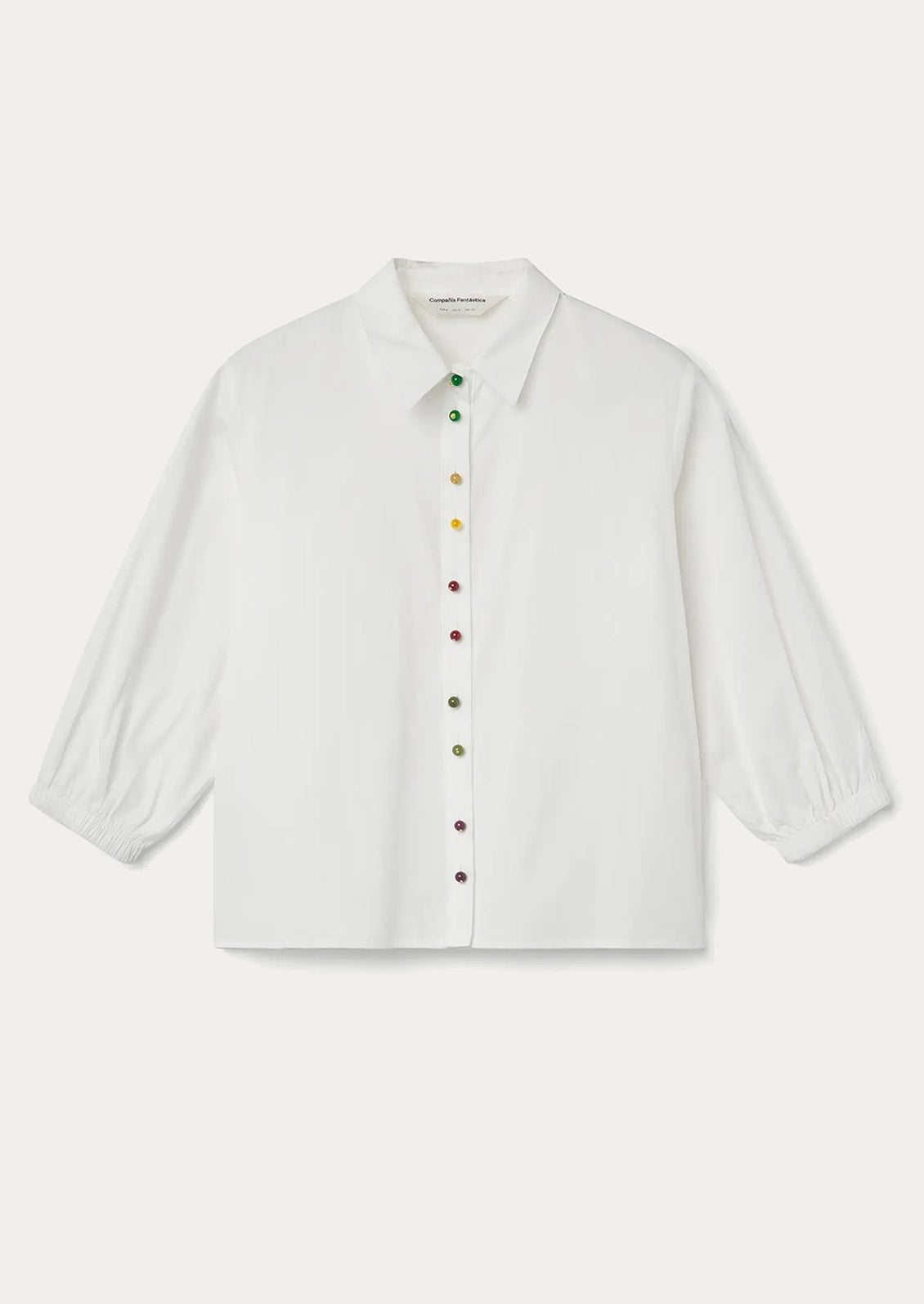 A white shirt with multicolor beaded buttons.