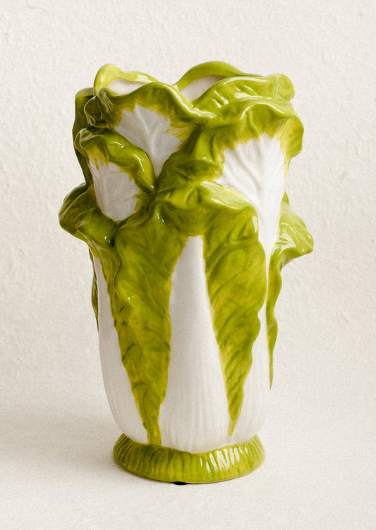 Vase designed to look like a head of lettuce on a white background