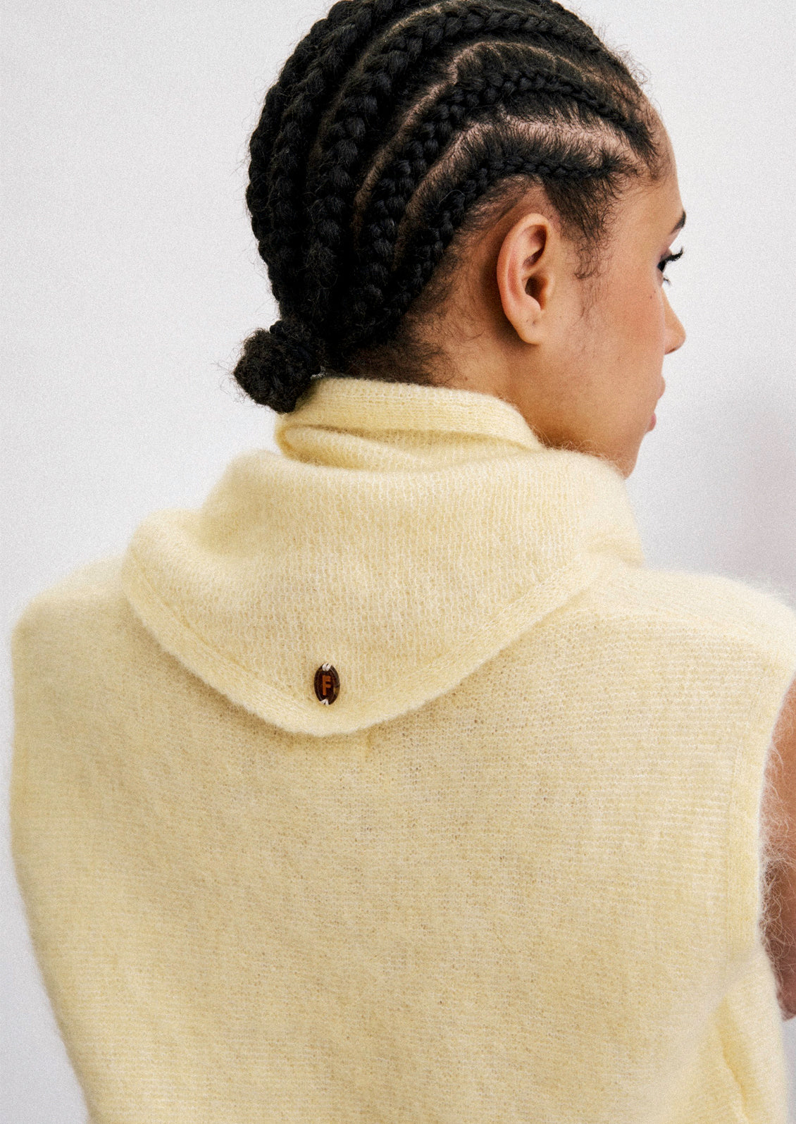 A woman wearing a mohair blend top and scarf in a canary yellow color.