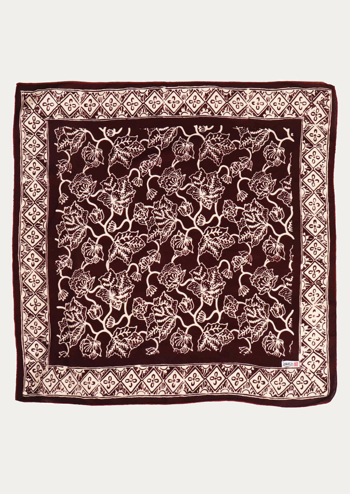 A square cotton bandana in dark plum color with white floral print and diamond border.