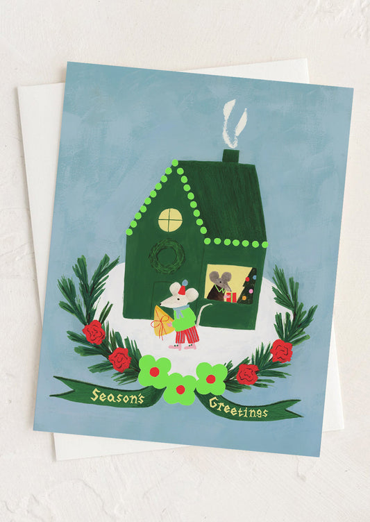 A greeting card with illustration of mice in a house, text reads "Season's Greetings".