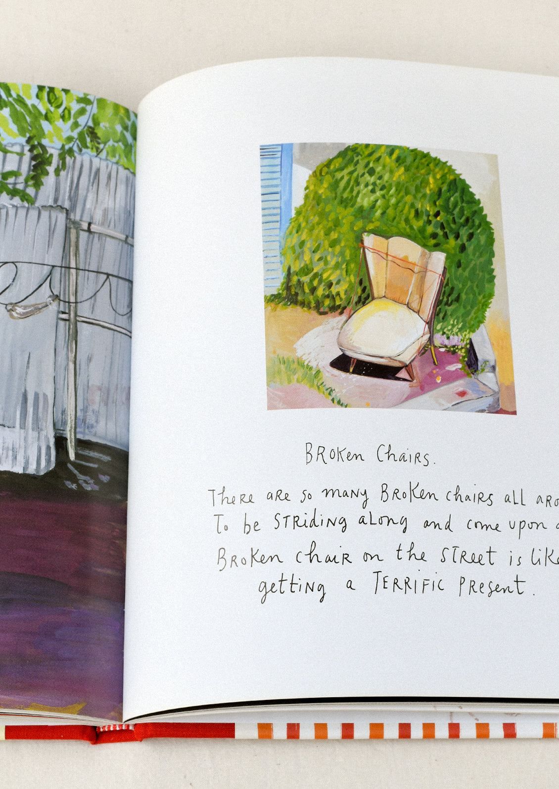 A book titled 'My Favorite Things' by Maira Kalman open on a table showing an illustration of a chair on handwritten text.