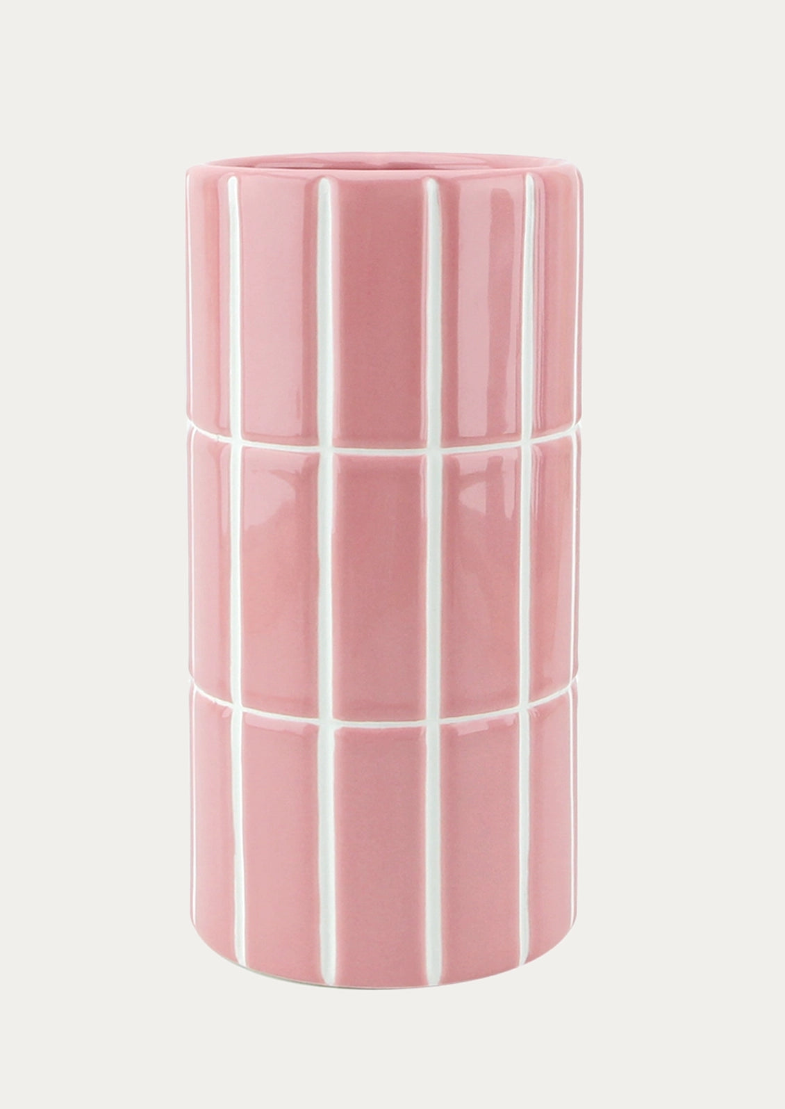 A tall, cylindrical ceramic vase in a bubblegum pink color, decorated with a white grid pattern.