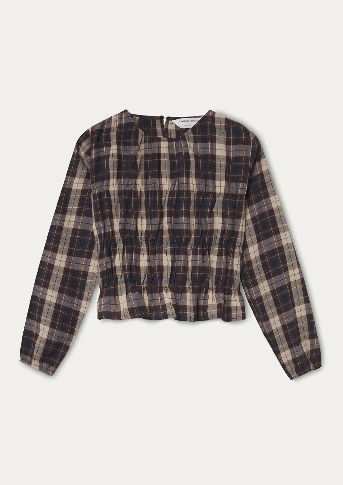 A long sleeve plaid top in brown, blue and cream with smocked detailing throughout.