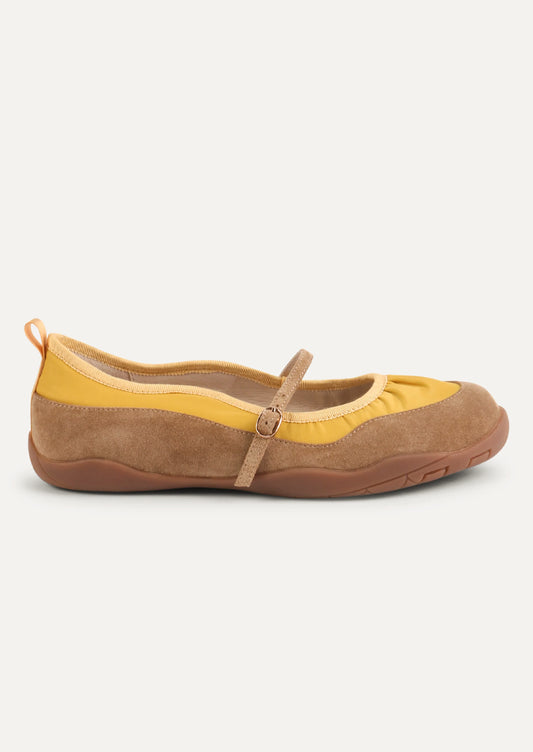 A yellow and taupe shoe that is part sneaker, part ballet flat mary jane. Suede/textile upper with a rubber gum sole.