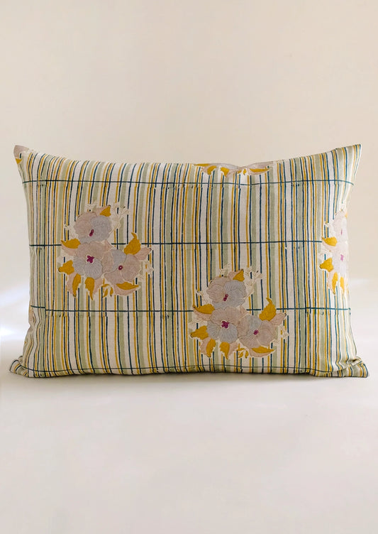 A throw pillow with stripe and floral pattern.