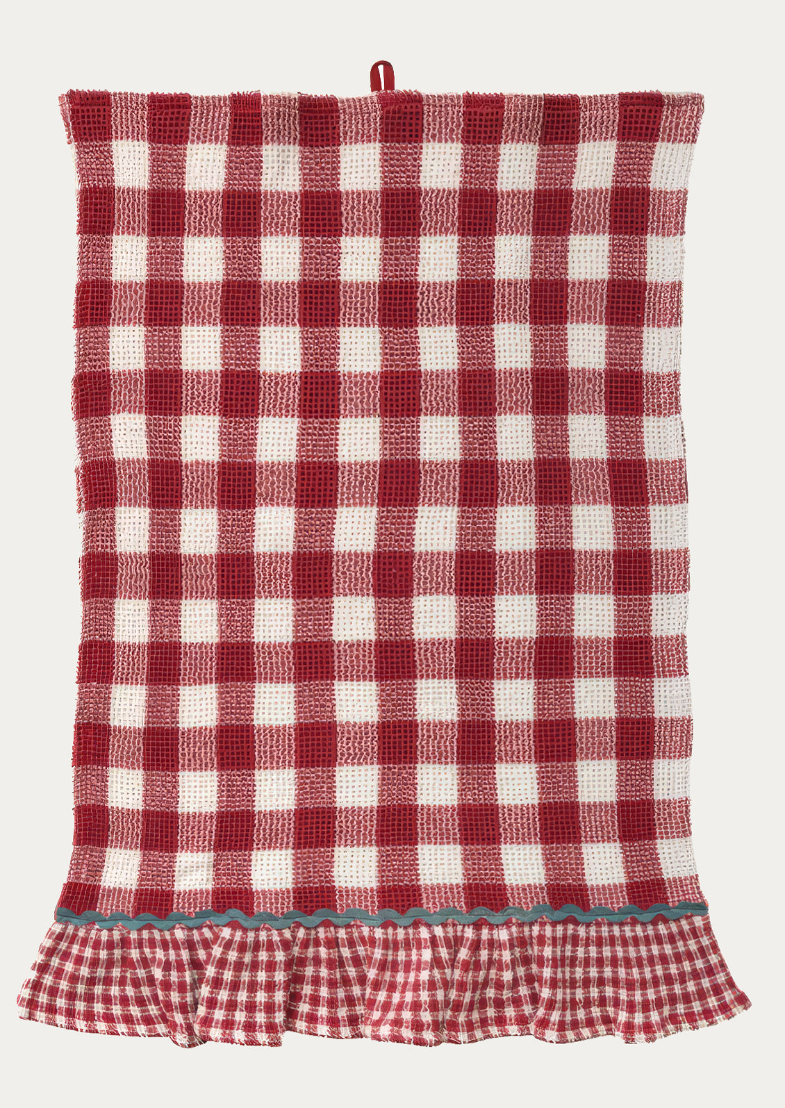A waffle textured tea towel in red gingham pattern, ruffle at bottom in smaller scale gingham with contrast ric rac trim.