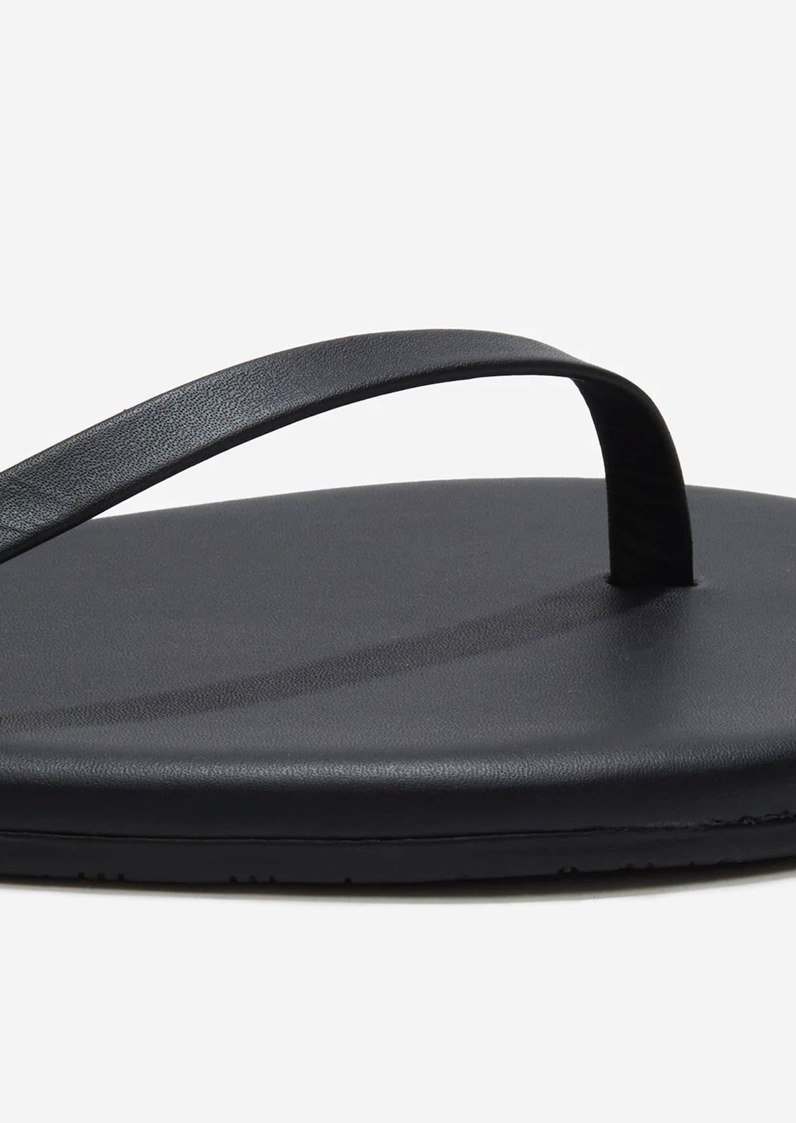 A black leather strappy sandal by TKEES.