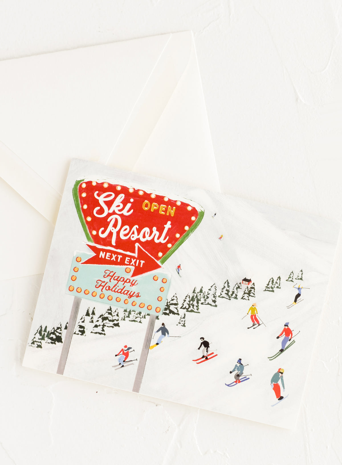 An illustrated greeting card with image of skiers on a hill.