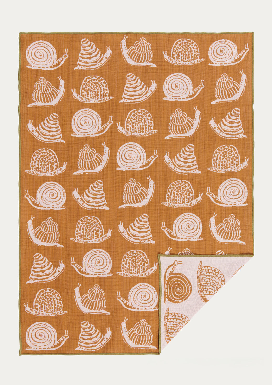 Patterned fabric tea towel with ochre snail pattern