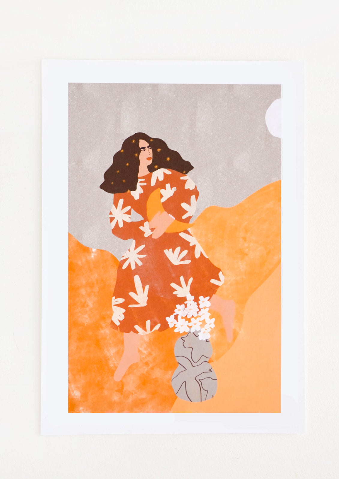 A long brown-haired woman in a rust colored floral dress holds a crescent moon in her arms as she moves through an orange and gray world.