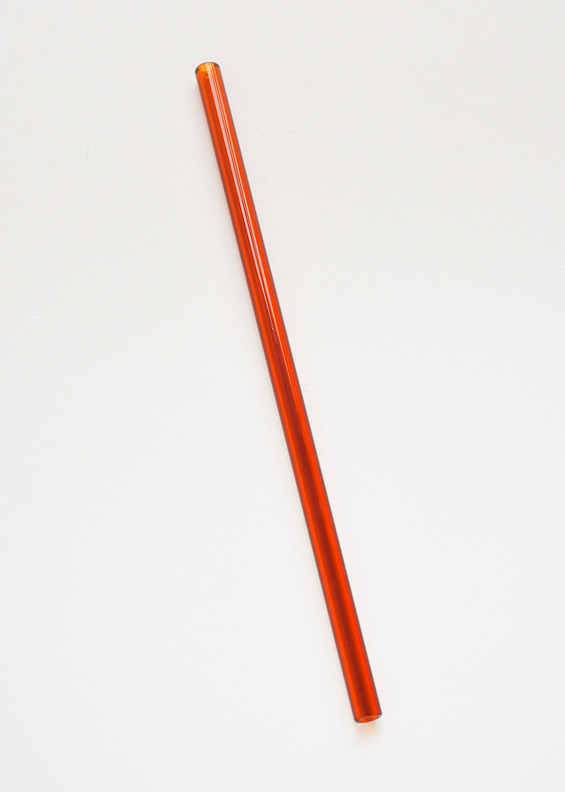 An amber colored glass straw.
