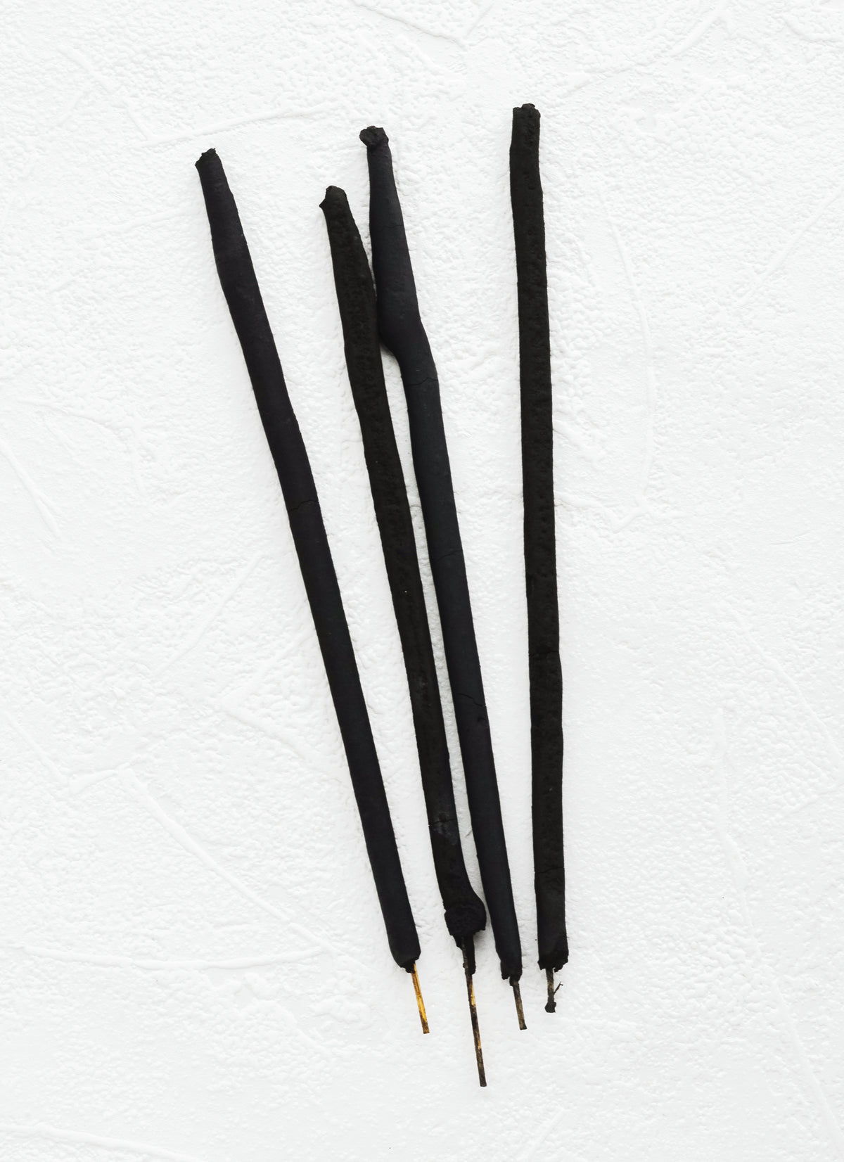 Black sticks of incense.