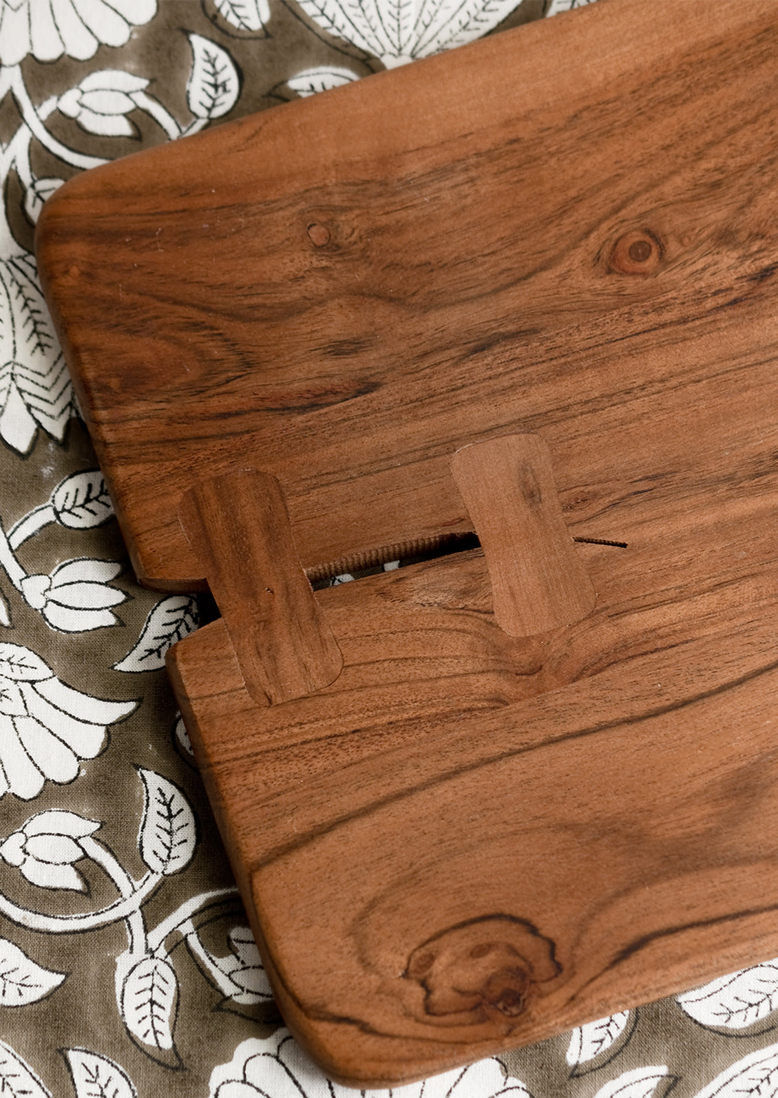 Bowtie inlay detailing on a wooden cutting board.