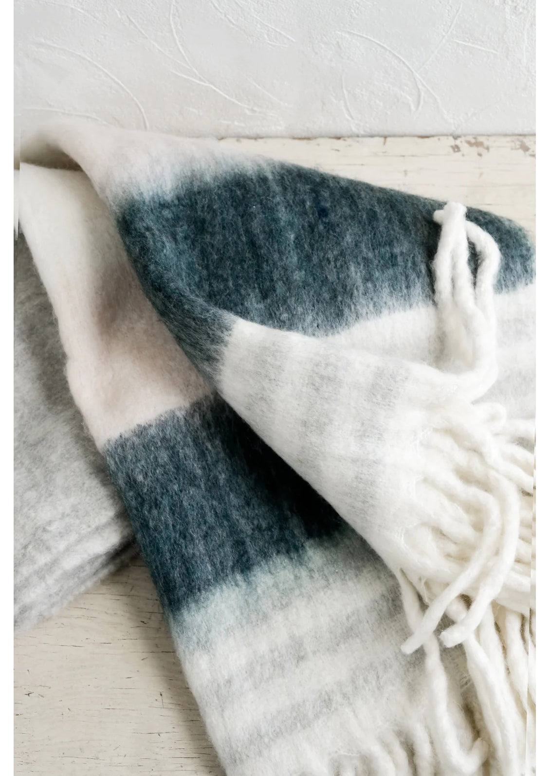 A striped throw blanket on a table.