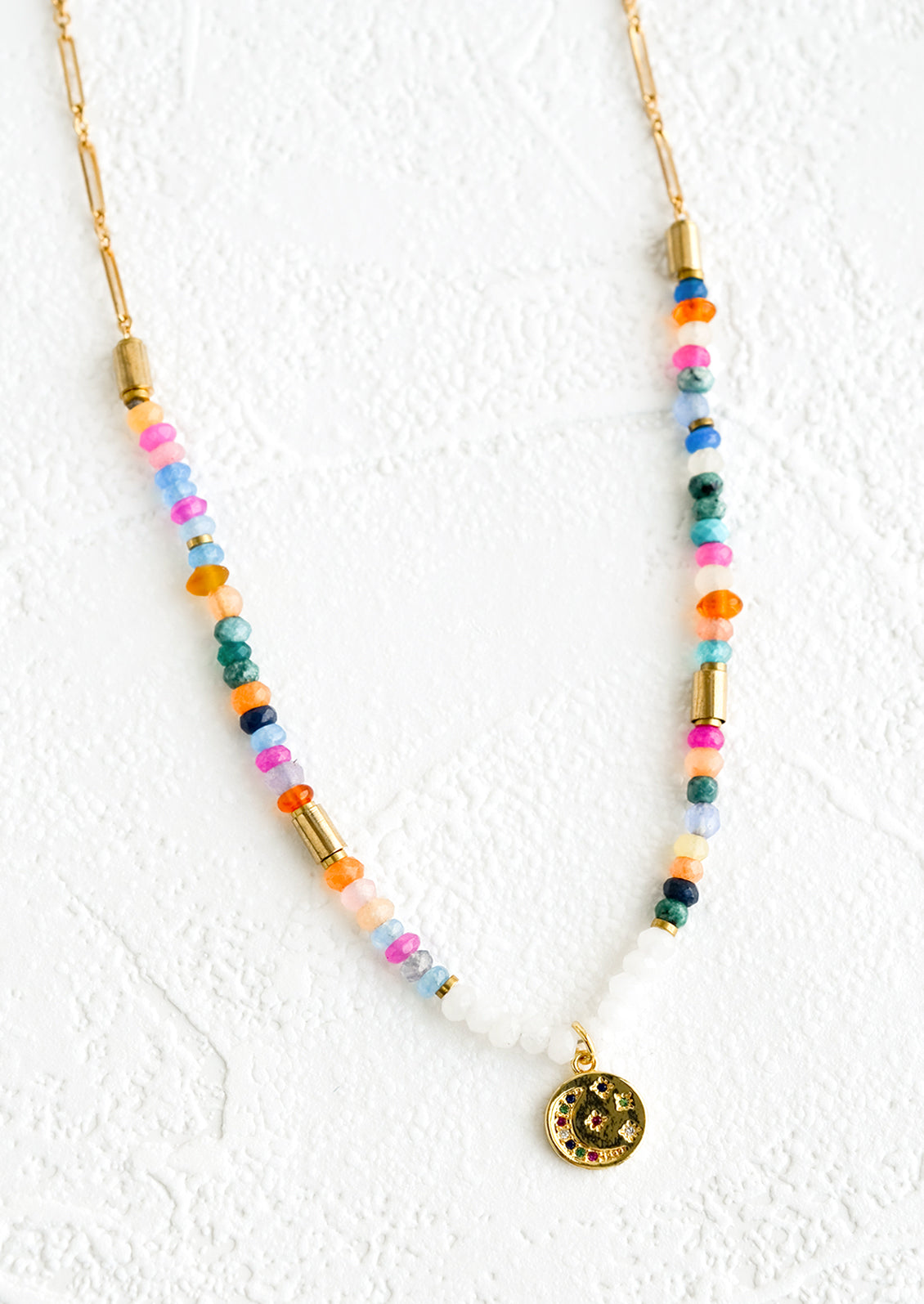 A necklace made of colorful rondelle beads with gold accents.