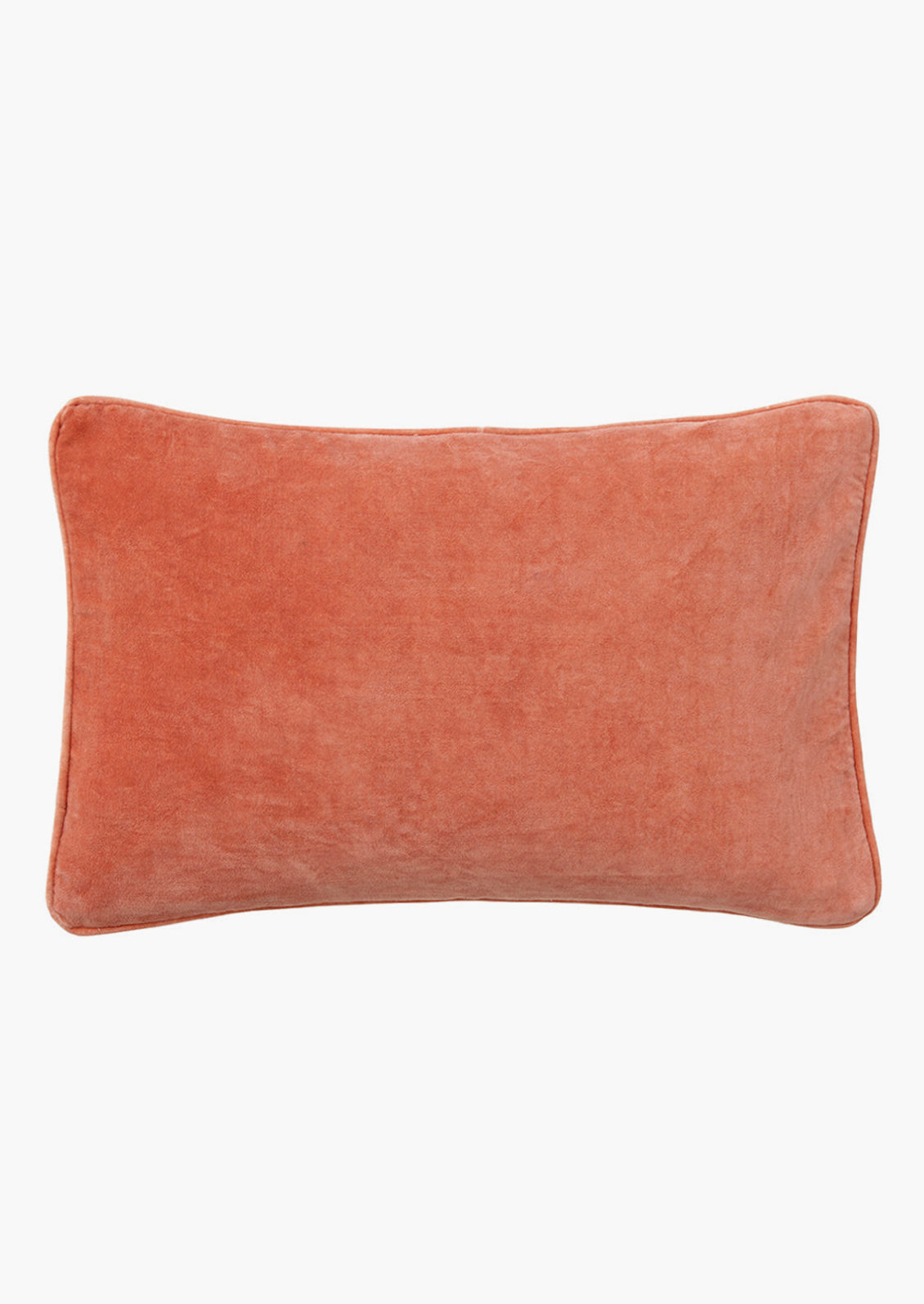 A lumbar velvet throw pillow in coral red.