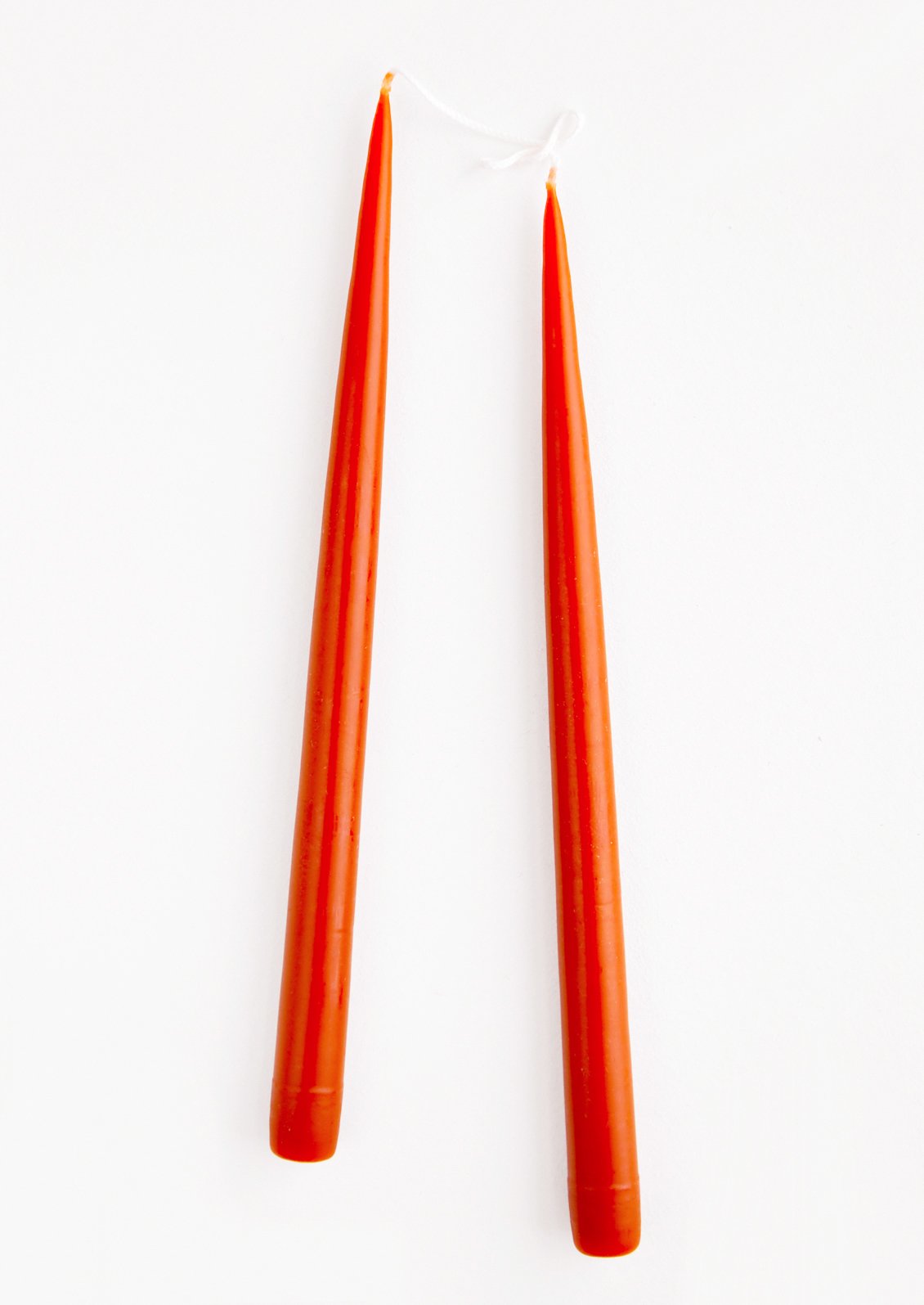 Pair of Taper Candles in deep red-orange.