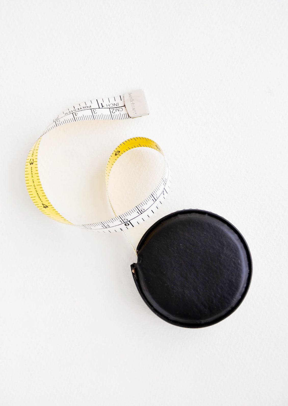 Tape measure covered in black leather.