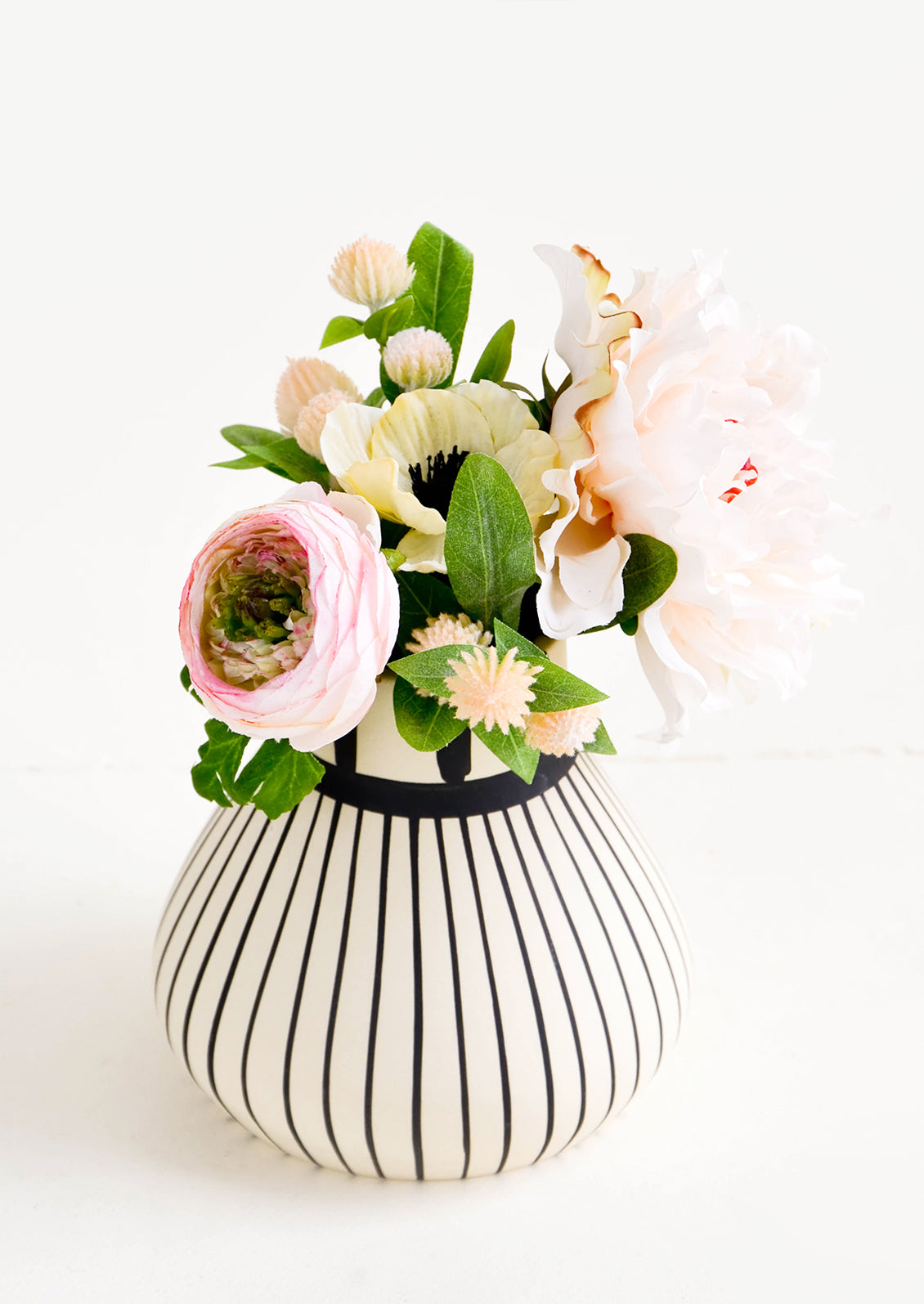 Black & white striped ceramic vase with a bouquet of flowers