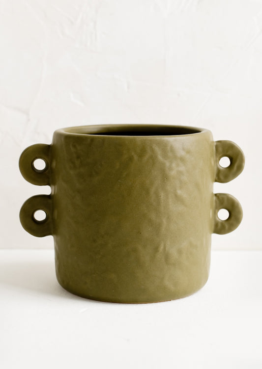 An army green round planter with decorative loop handles at sides.