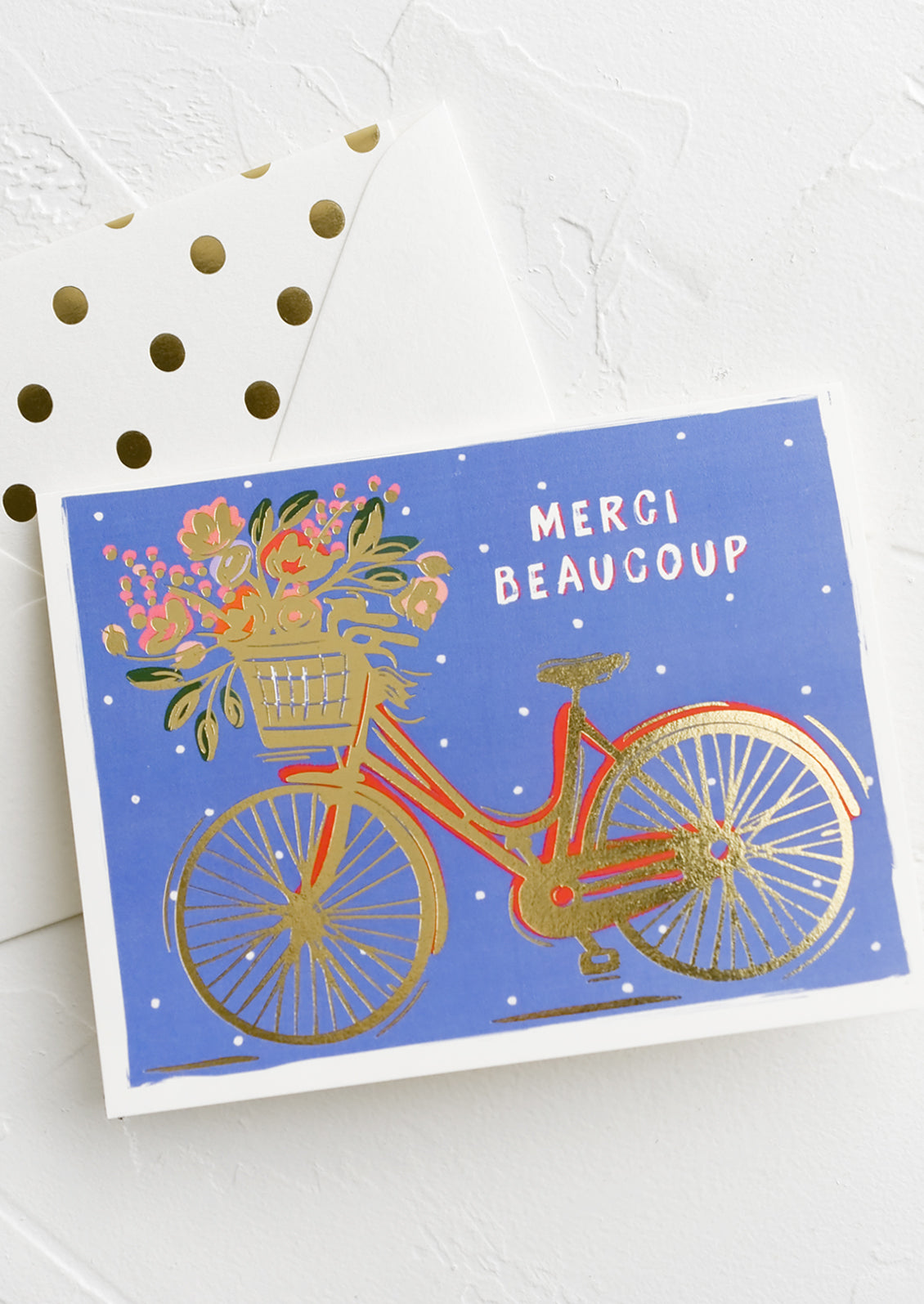 A greeting card with picture of bicycle and text reading Merci Beaucoup.