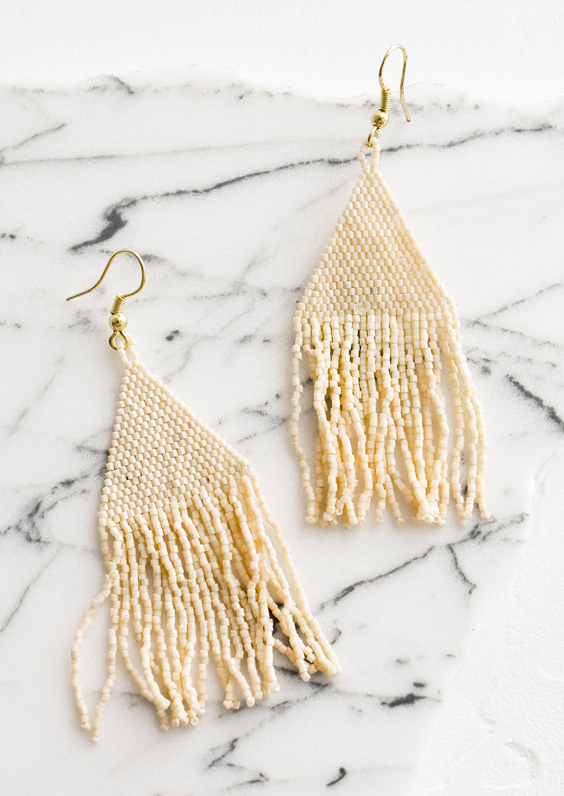 Metallic cream triangular fringe beaded earrings.