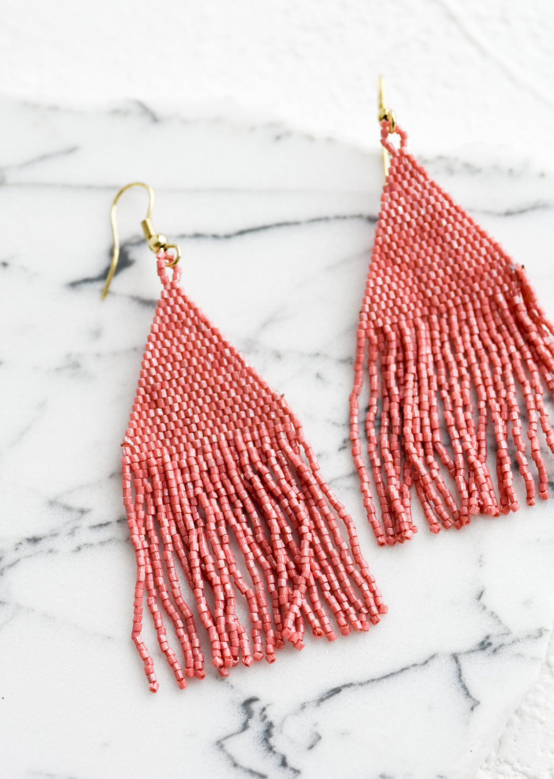 Metallic dark pink triangular fringe beaded earrings.
